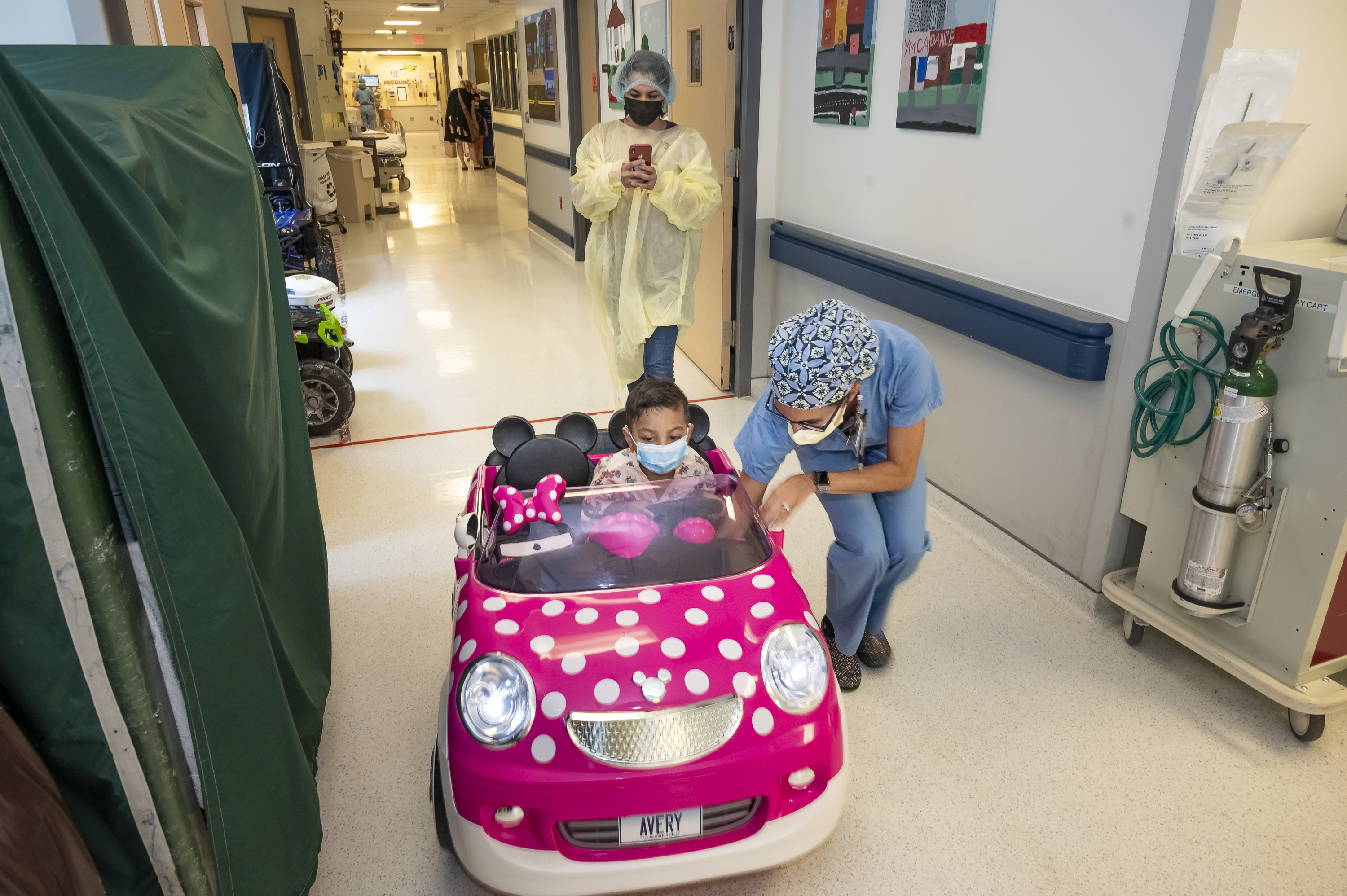 child drives mini mouse car 