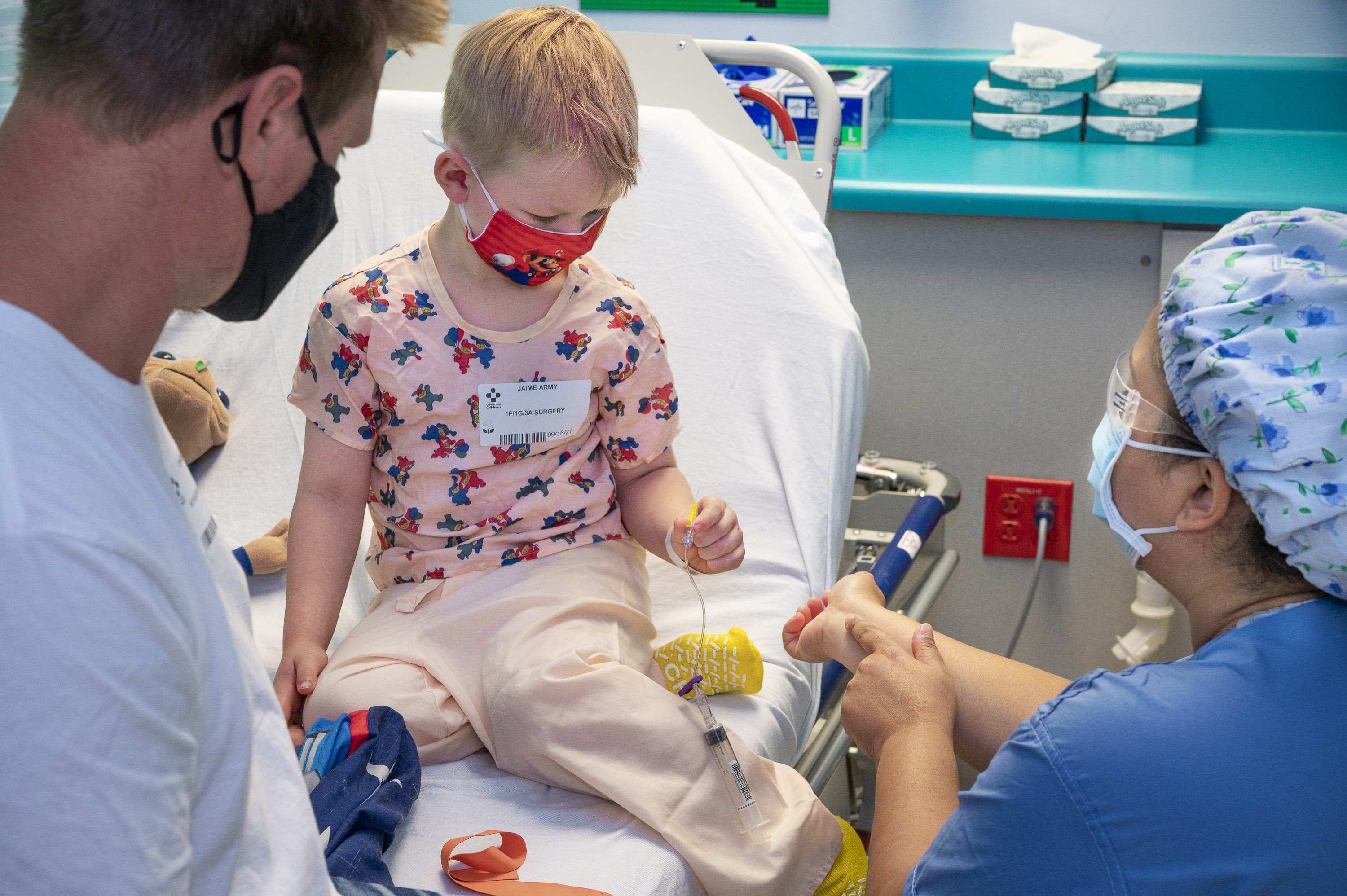 An IV is explained to a young boy