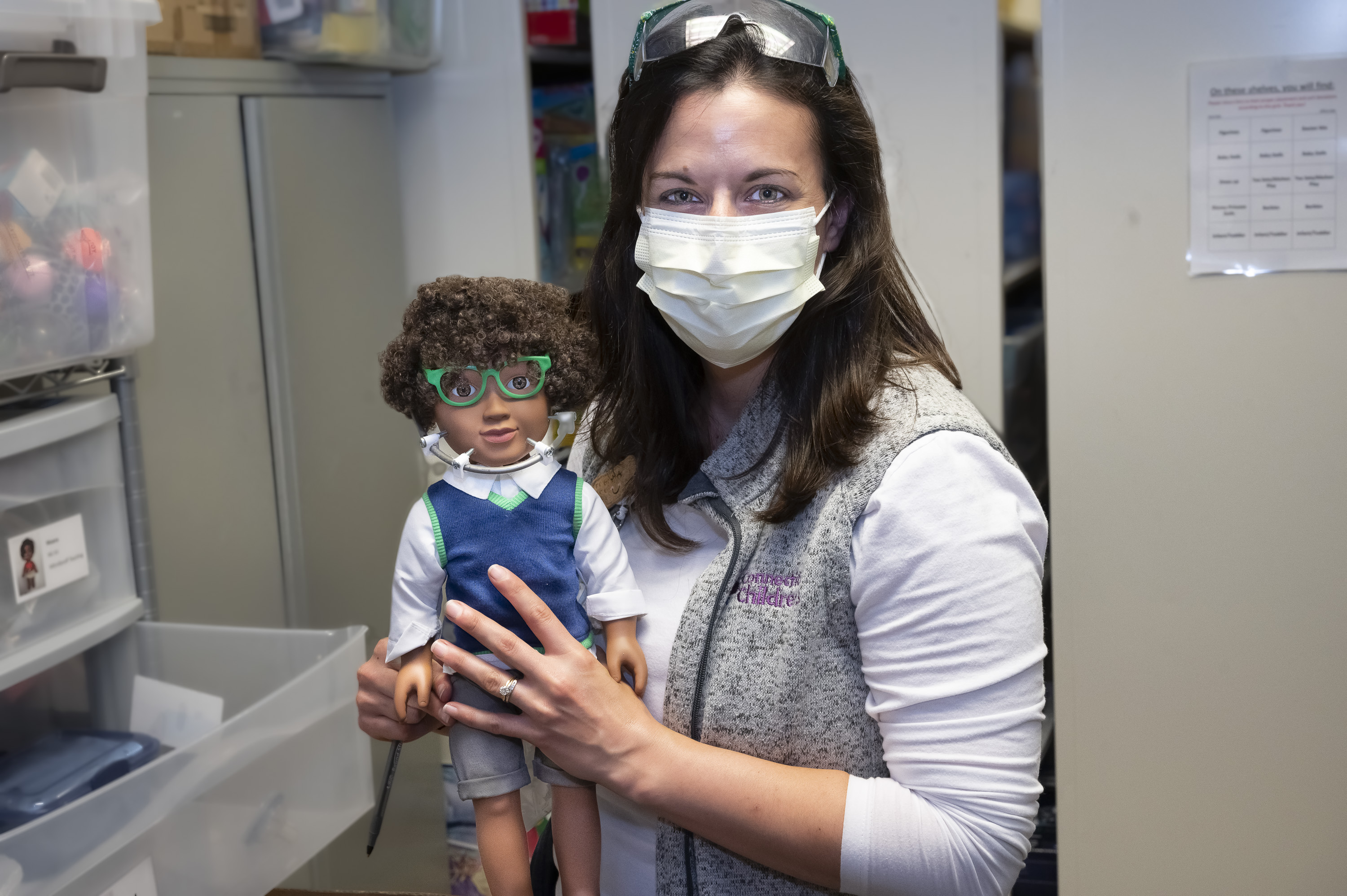 Child Life specialist holding a teaching doll