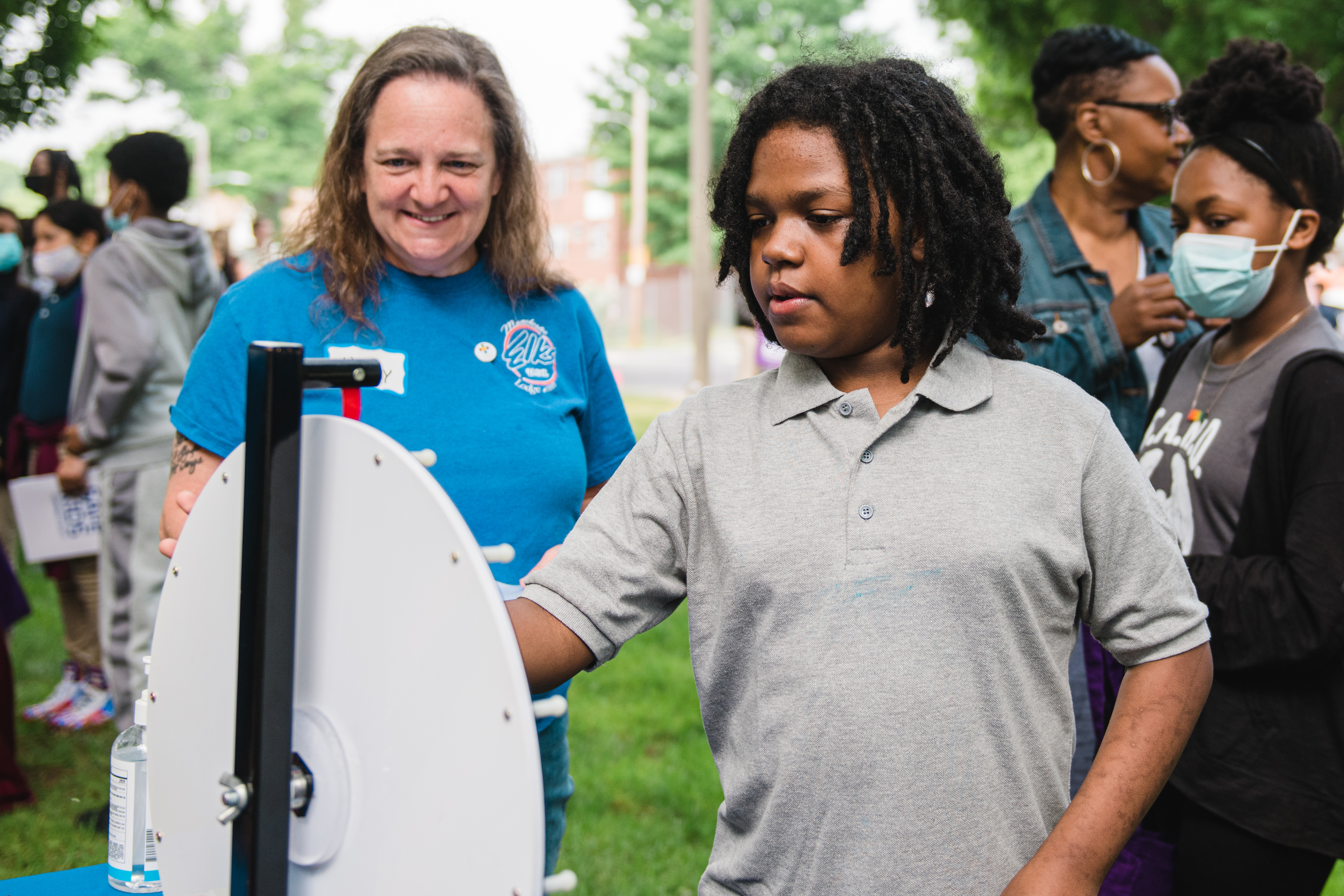 A student takes a turn spinning the safety trivia wheel