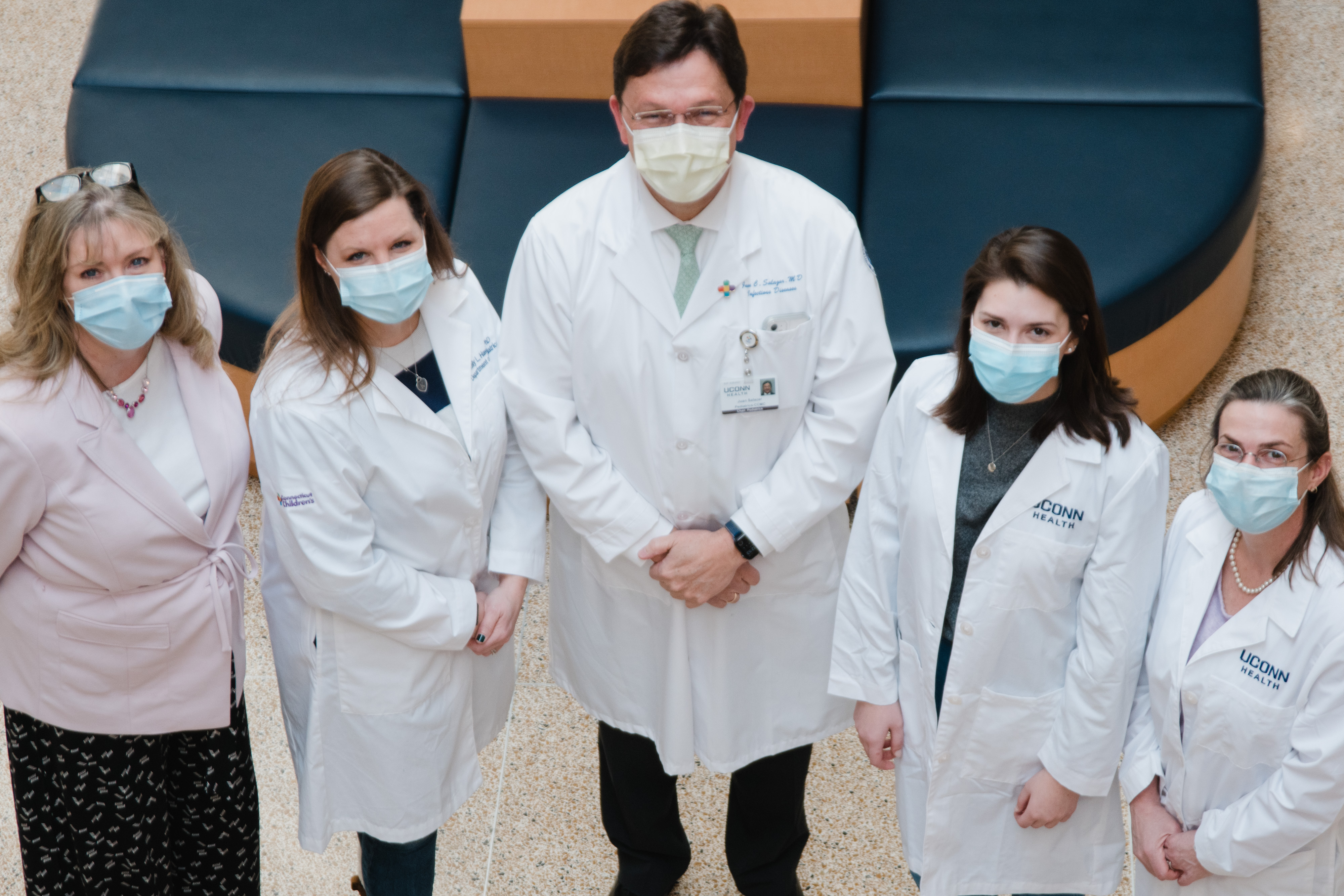 Juan Salazar, MD stands with his team of researcher colleagues.