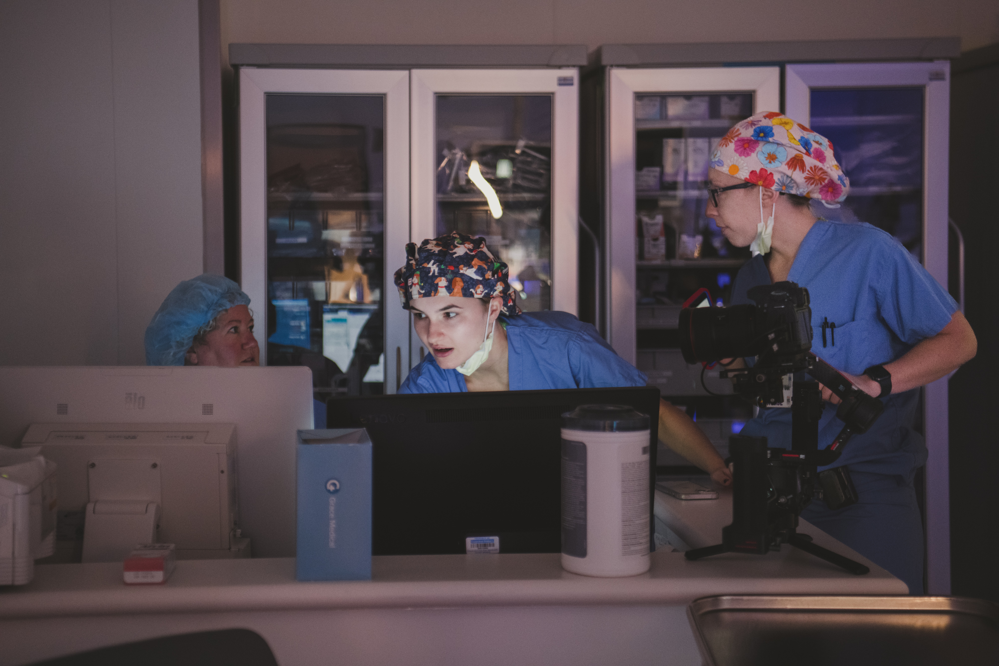 The medical team reviews patient information using sophisticated technology