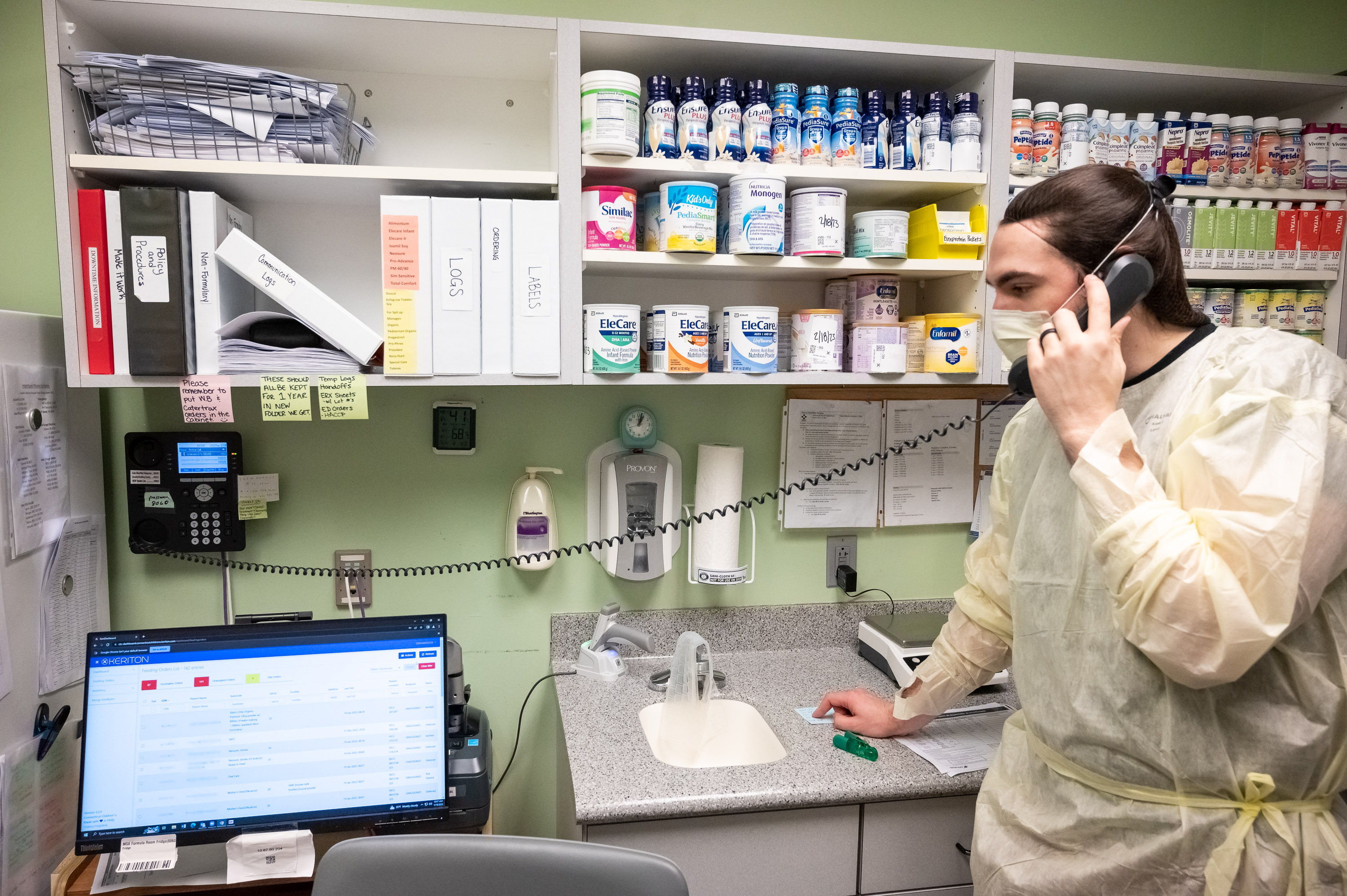 Milk technician Ethan Bamberger is speaking on the phone about one of the 100 varieties of formulas he manages.