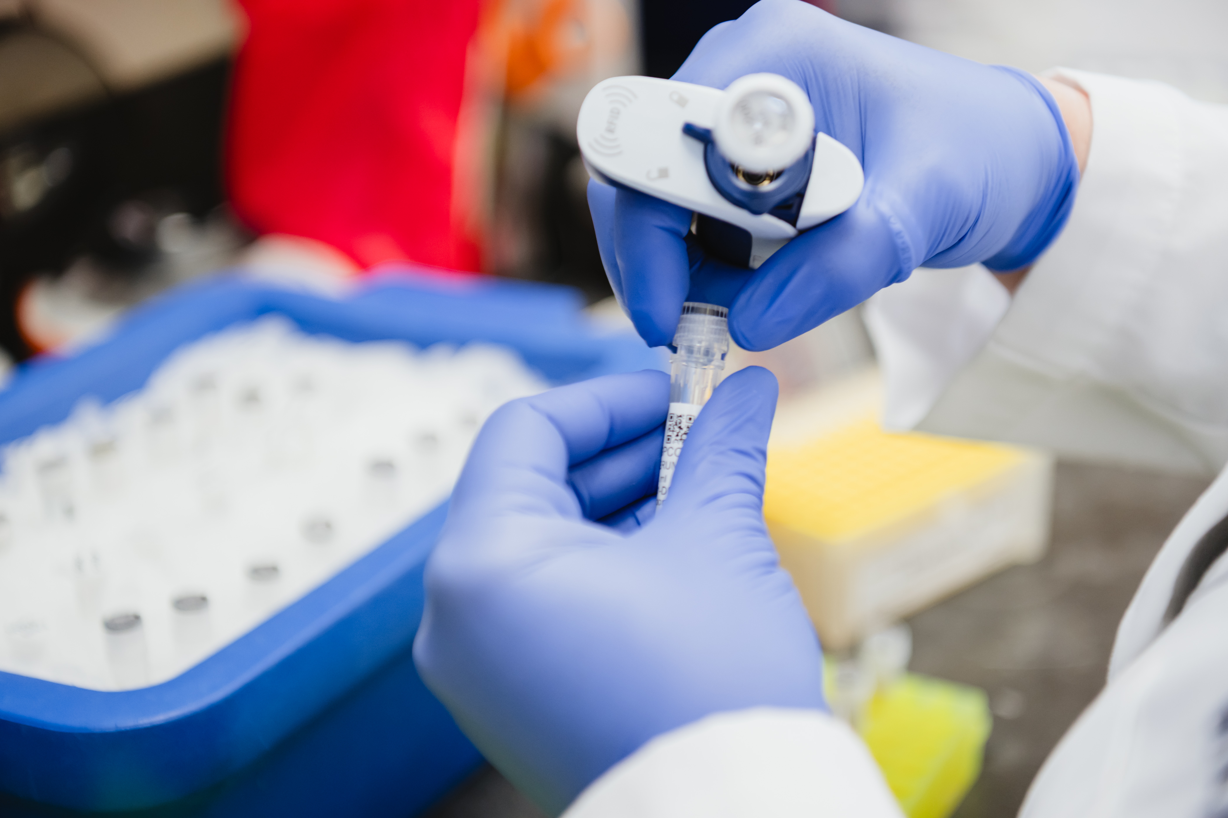 A research associate manages vials in the lab.