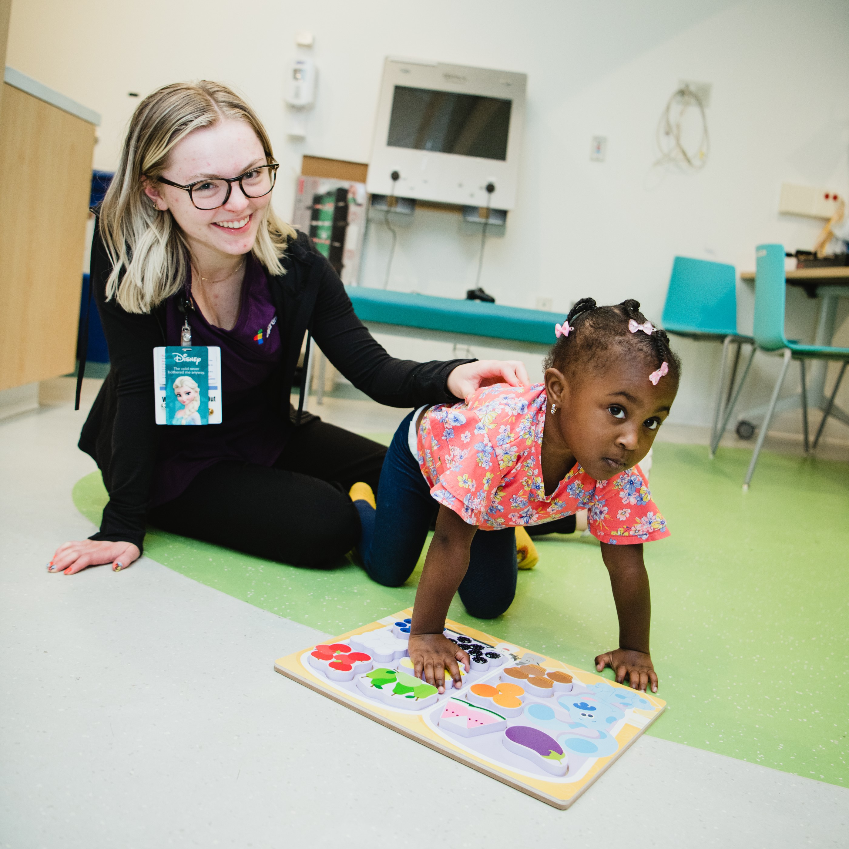 A patient engages with their care provider over a puzzle.