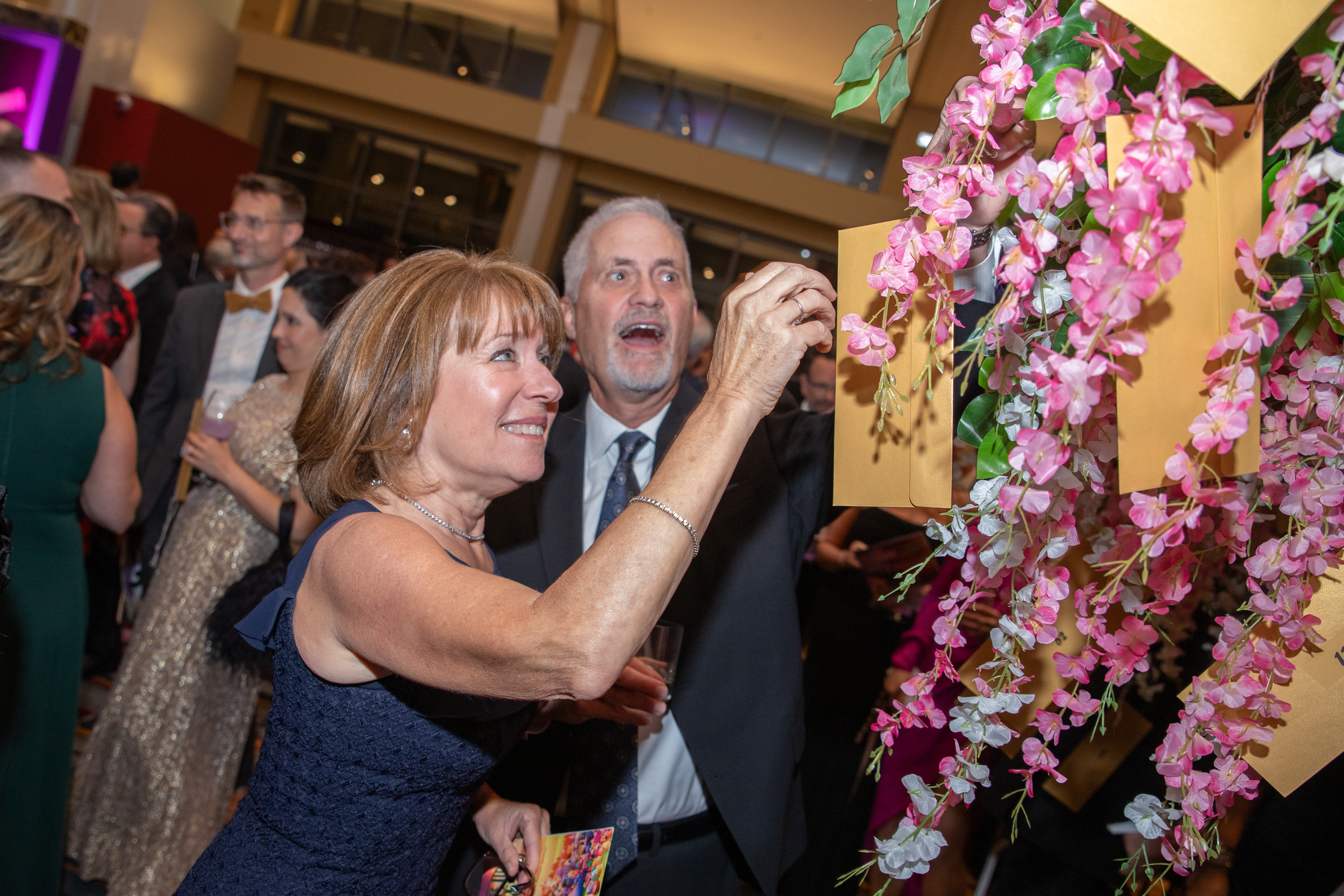 A guest selects a lucky Golden Ticket from Wonka's Wishing Tree!