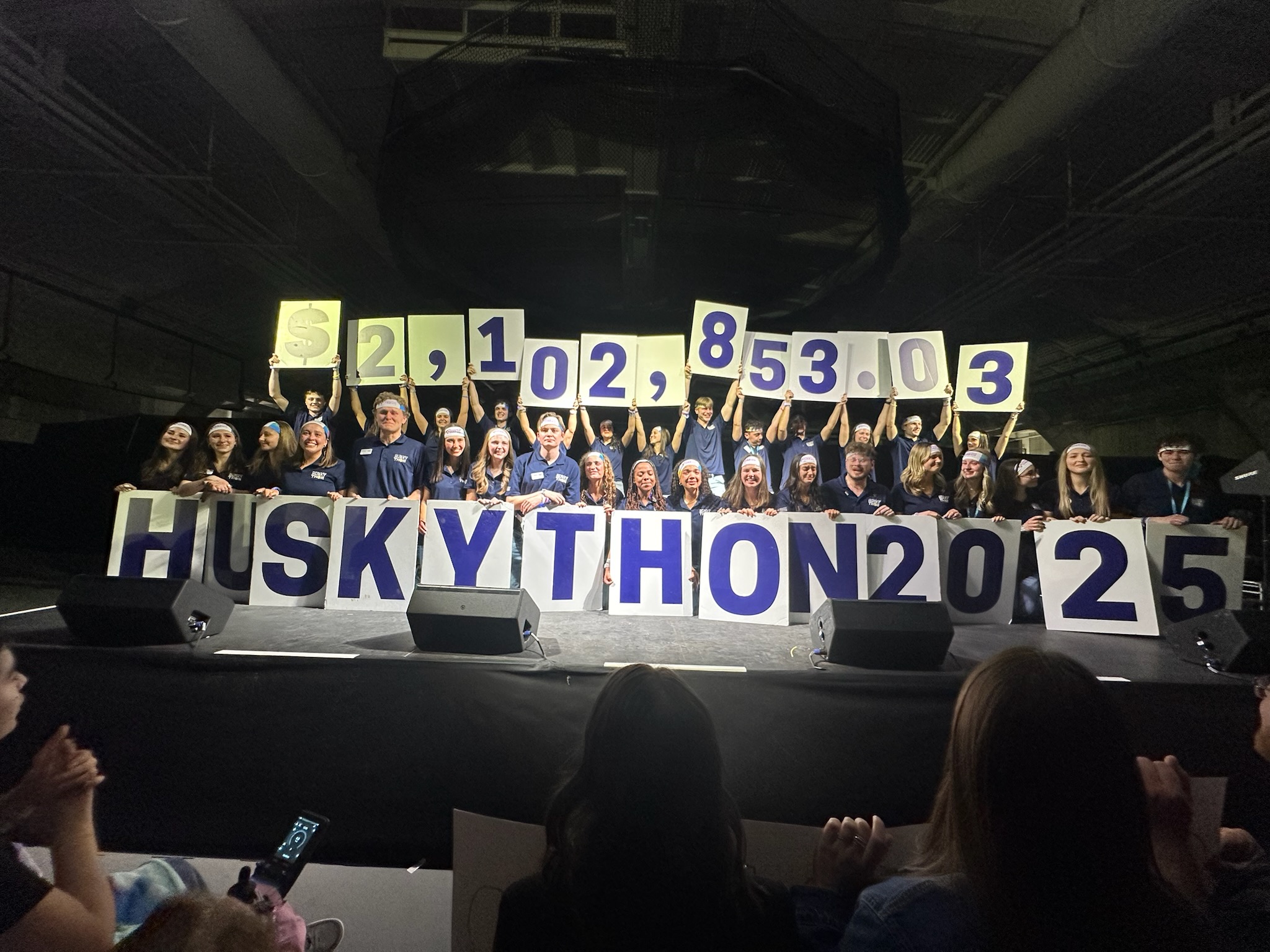 HuskyTHON 2025 Management Team breaking into tears as they announce having exceeded their most ambitious goal.