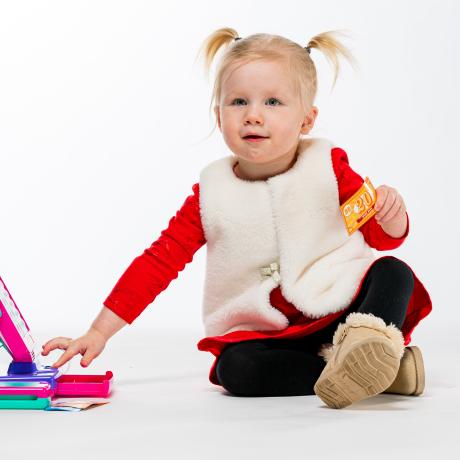 Cora sitting on the floor playing with toys