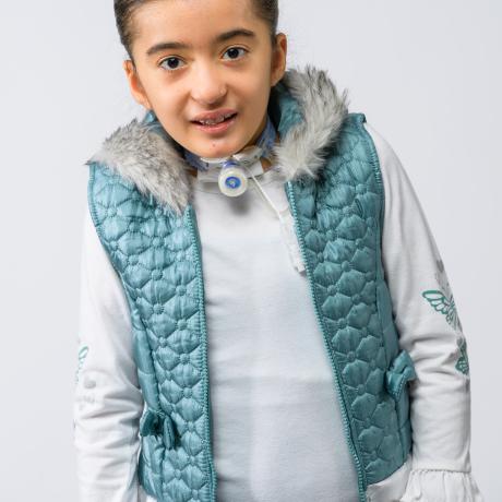 Ariella smiling in blue vest