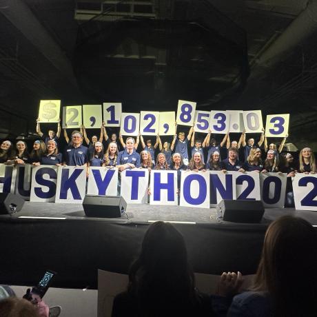 HuskyTHON 2025 Management Team breaking into tears as they announce having exceeded their most ambitious goal.