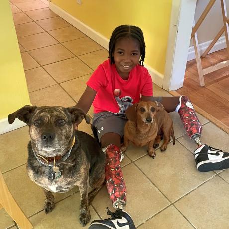 Nate smiling with his dogs