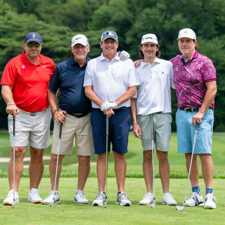 Geno and a team of golfers