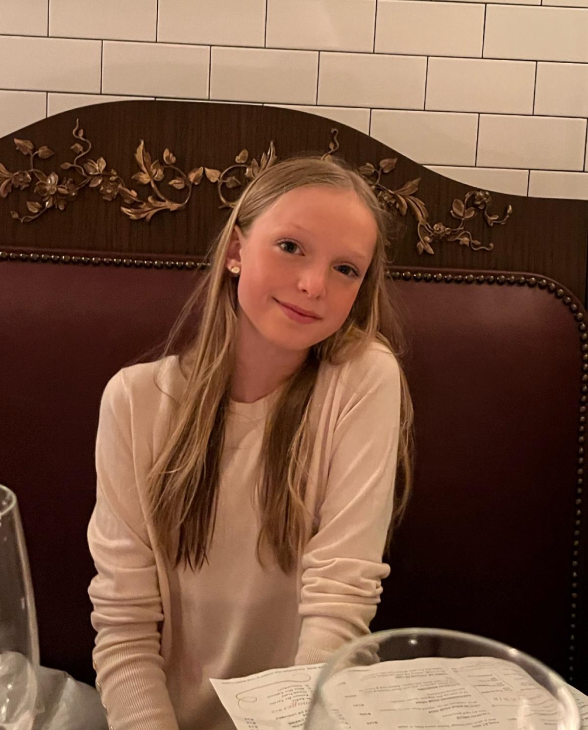 Chloe smiling in restaurant