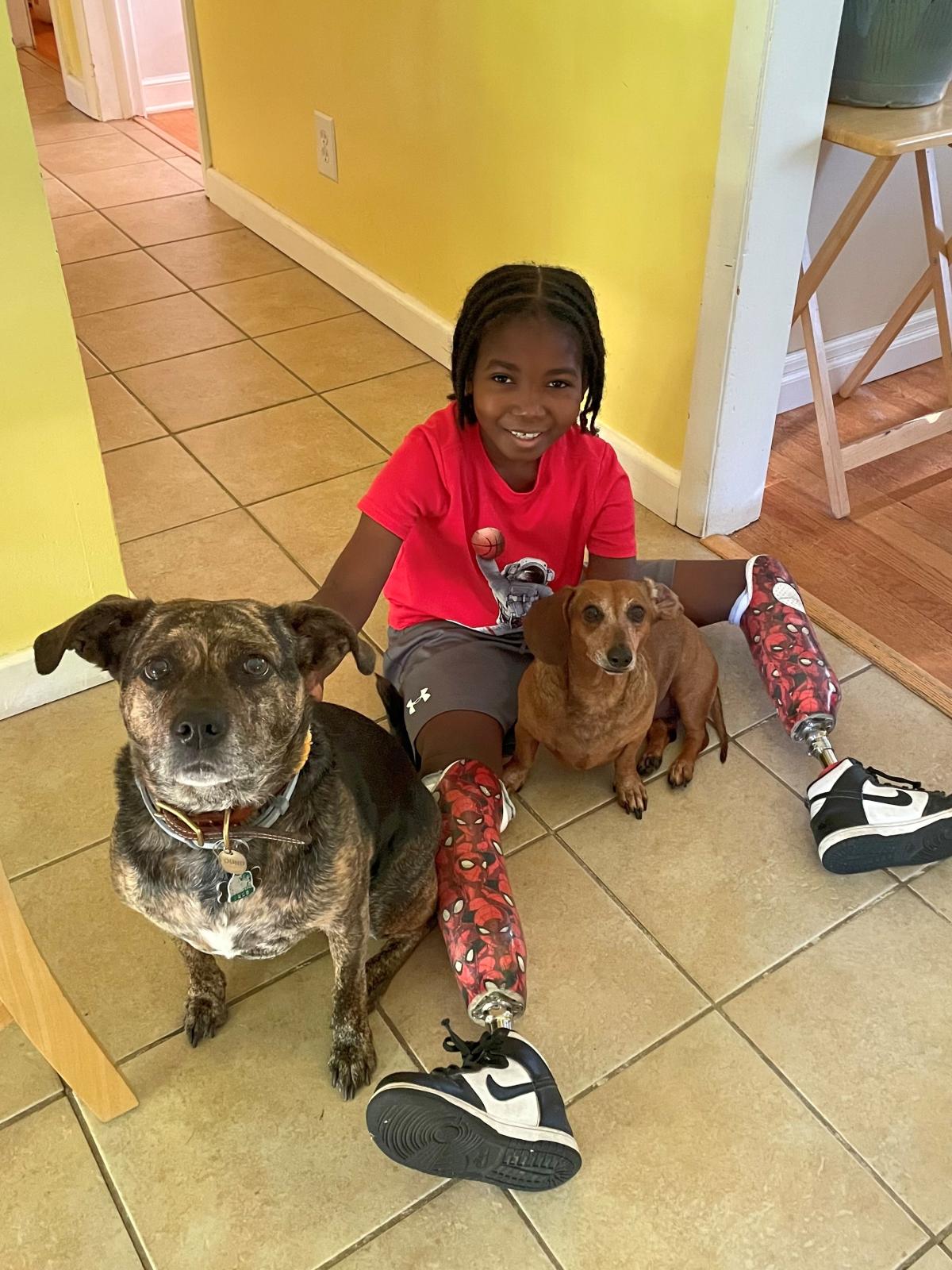 Nate smiling with his dogs