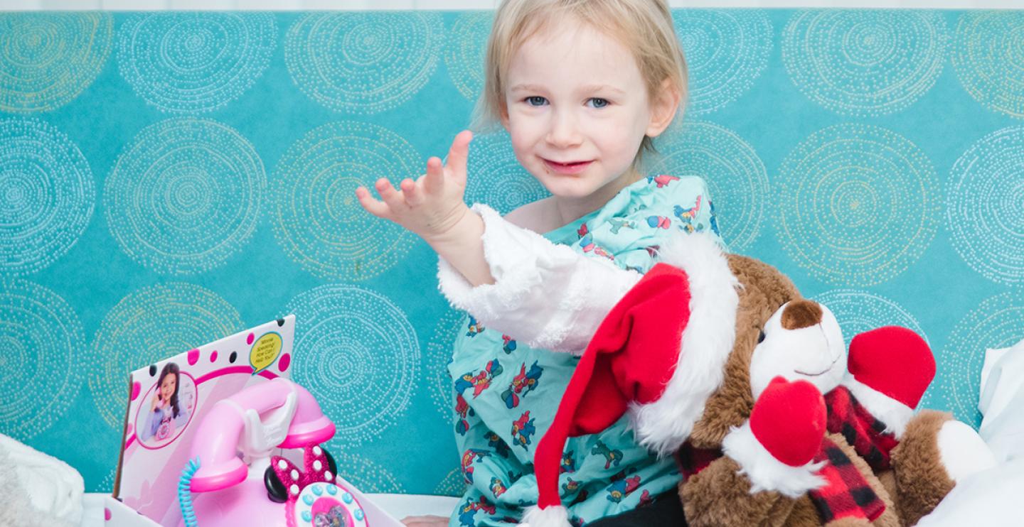 A patient receives toys from the Snowflake Shop